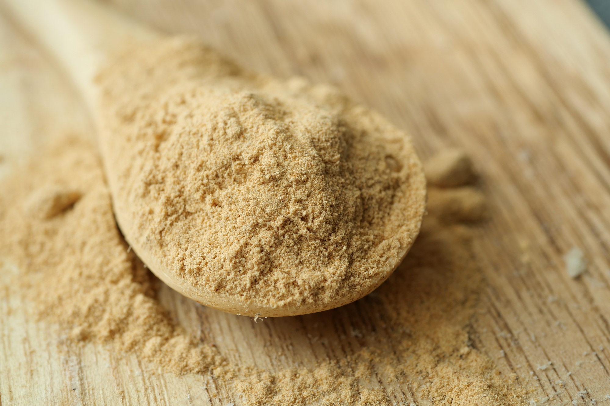 mixing brewers yeast flakes in a glass of water