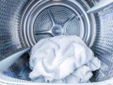 Inside of tumble dryer with clean white towels - new generation of dryer